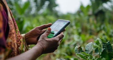 woman using mobile finance, reflecting the mobile internet fueled a financial transition in Rwanda